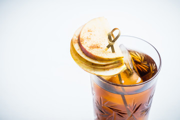 Cocktail with cola, apples and whiskey. Selctive focus.