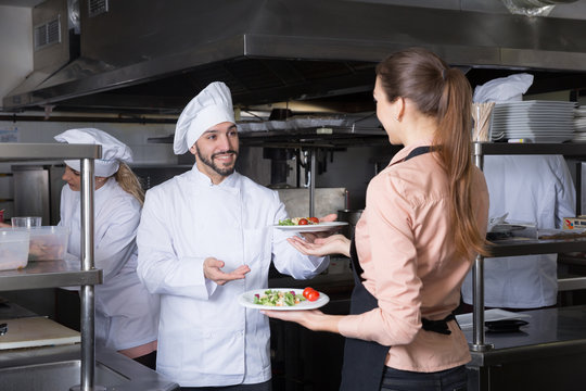 Staff of restaurant with head chef working