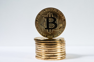 New virtual money Golden bitcoin coin on a white. Cryptocurrency. Business and Trading concept.