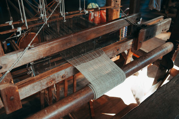 Lotus weaving shuttle on an old manual weaving machine