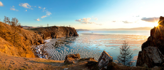 Lake Baikal in the May ice drift. Panoramic view of the coastal cliffs of the island of Olkhon near the village of Khuzhir in the sunset