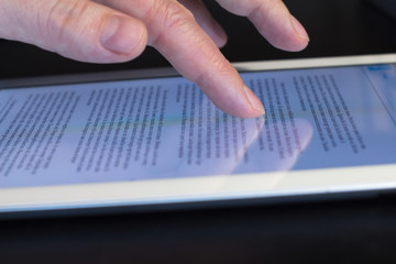 Fototapeta na wymiar closeup scrolling finger touching tablet