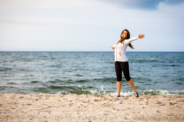 Young woman walking on beach