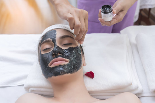 Beautiful young Asian women having mud mask for spa treatment in spa salon