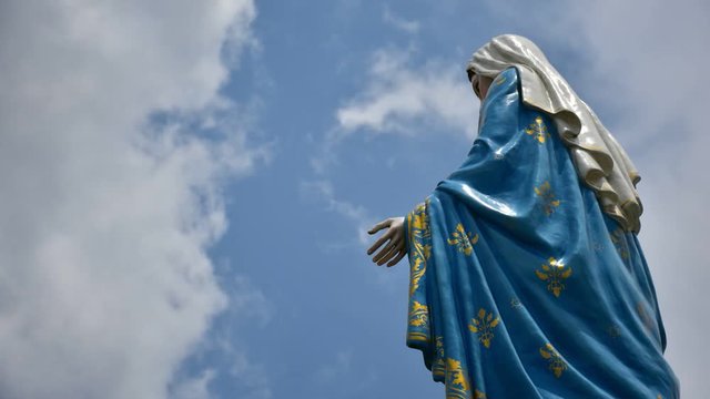 The Virgin Mary statue with moving clound on sky at The Cathedral of the Immaculate Conception, Timelapse