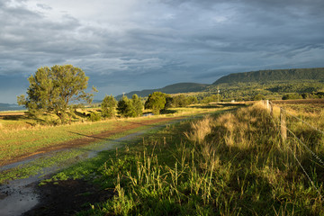Australian landscape with farm fence after storm