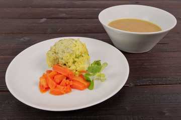 Rice with vegetables and herbs on a table