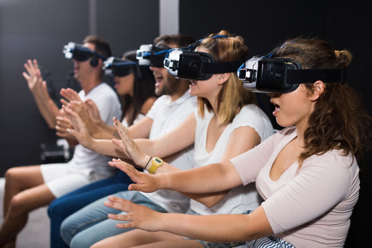 scared girl on virtual reality attraction sitting with another people