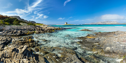 Sardinia la pelosa stintino panorama view from the beach coast on ancient tower turquise blue sea...