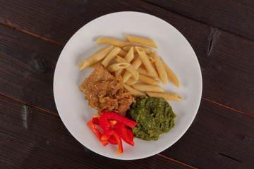 Tempeh with spinach and pasta on a table