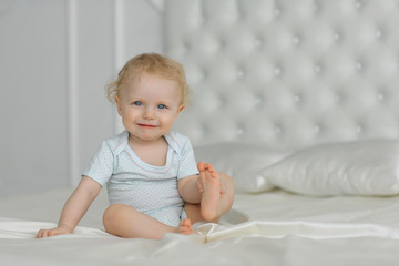Little girl sit on the bed