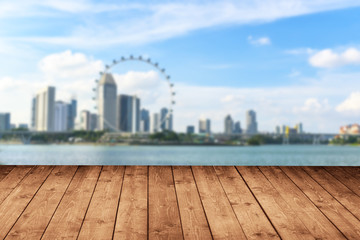 Wooden floor with blurred of cityscape skyline and beauty sky in background,use for backdrop or design element in tropical summer concept.