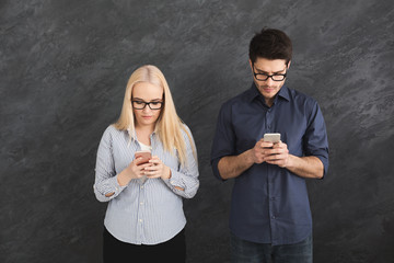 Young couple ignoring each other with phones