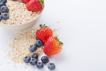 Oatmeal with fresh fruit. Strawberry and blueberry.
