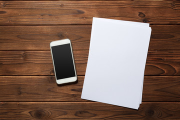 White business card on wooden table. Blank portrait A4.