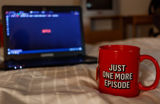 Watching series with a cup of tea. Just one more episode. Millennial concept