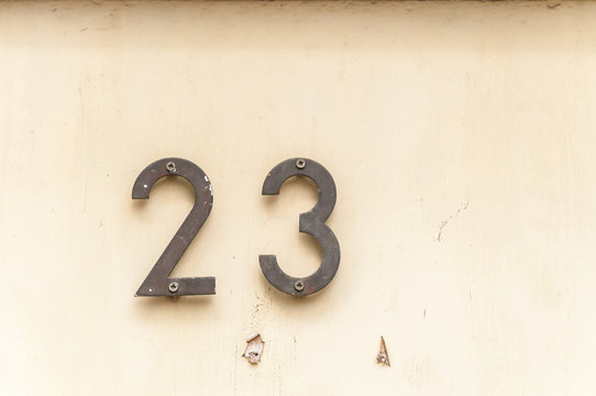 Old Vintage House Address Metal Number 23 On The Plaster Facade Of Abandoned Home Exterior Wall On The Street Side