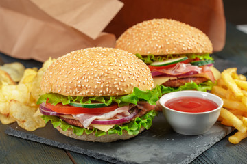 Fast food, homemade burger on a wooden background