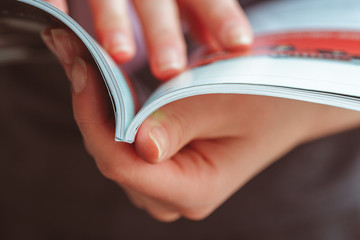 woman reading magazine at home