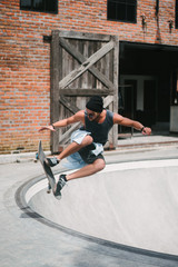 handsome skater jumping during skating in skatepark