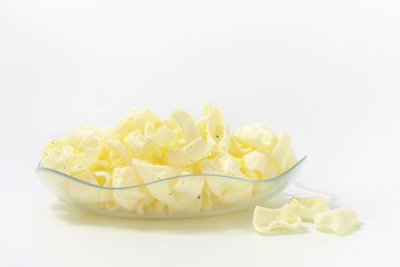 golden potato chips on a white background.