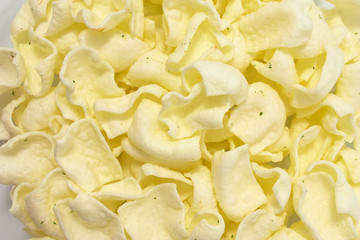 golden potato chips on a white background.