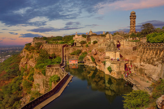 a stone fortress on the hill of fort chittorgarh in india in evening at sunset. architectural landmark