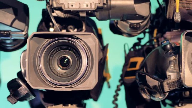 Close up footage of cameras' lenses from right to left