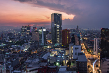 Aerial view of mexico city downtown skyscrappers at sunset time before night.