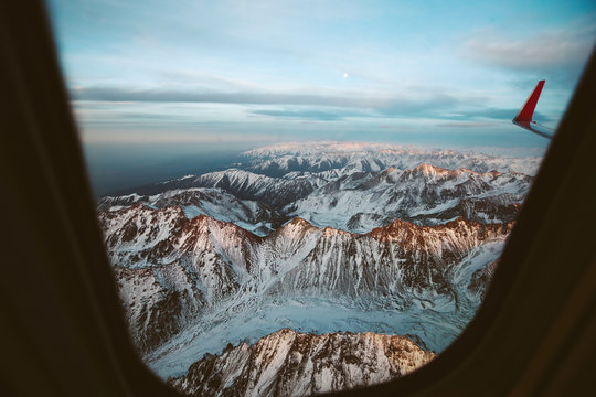 Fototapeta Mountains view through window of aircraft
