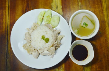steamed rice topping boiled chicken with sauce and soup
