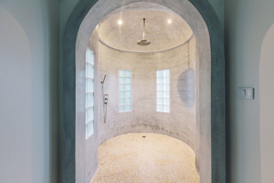 Modern luxury shower design in villa interior. Concrete walls, minimalism