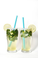 Fresh and cold Mojito cocktail on a white background. Two mojitos with drinking straw