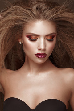 Beautiful blond model: curls, bright makeup and red lips. The beauty face.