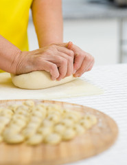 Obraz na płótnie Canvas Close-up of woman's hand kneading dough