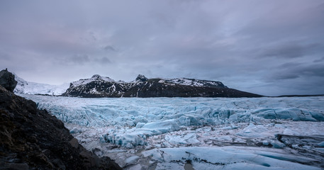 Naklejka na ściany i meble Panorama landscape view of Icelandic Glacier at cloudy evening in Iceland