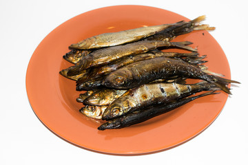 Smoked Baltic herring fish in a plate,