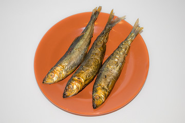 Smoked Baltic herring fish in a plate,