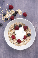 Vertical image of granola cereal on a blue stone background 