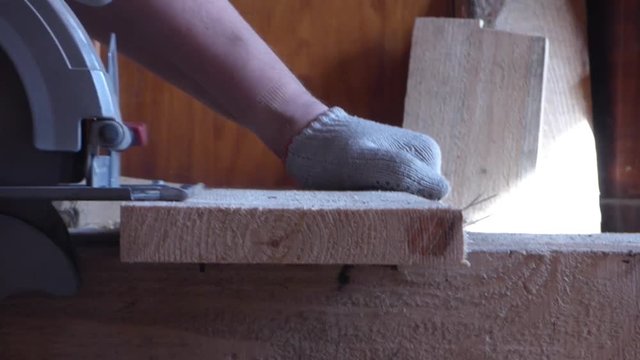 Caucasian man working with circular saw in carpenters workshop