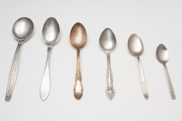 Old spoons close up on gray background