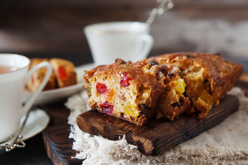 Traditional fruit cake pudding with dried fruits on wooden board