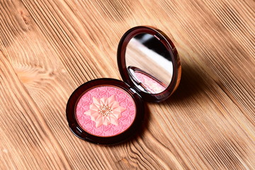 Opened blusher on white wooden table