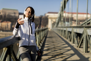 Woman on the bridge making a pause after the exercise