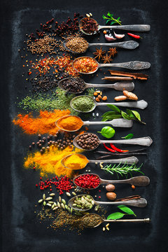 Plakaty Herbs and spices for cooking on dark background