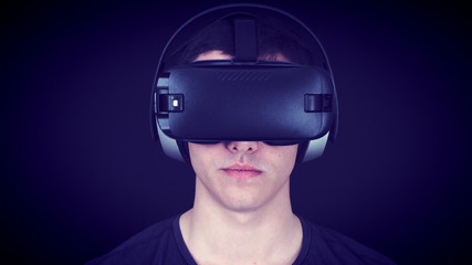 Young man wearing VR Headset and experiencing virtual reality. Blue Concept