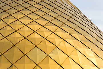 Close up shot of a golden dome of a church, cathedral or mosque. Background metal yellow rectangle pattern