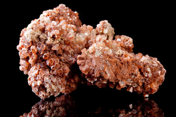 Vanadinite is a mineral containing the metals vanadium and lead and showing red hexagonal crystals