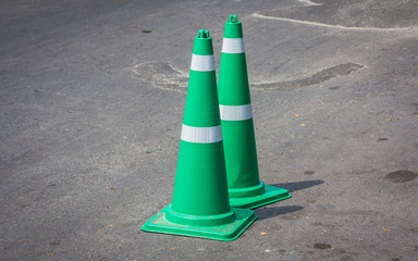 Green traffic cones laid on the road