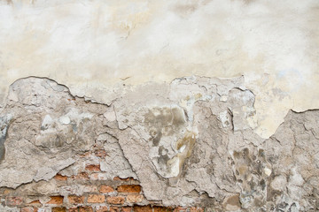 Old red brick and white plaster wall with cracked shabby surface texture background.
